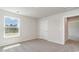 Neutral bedroom with soft carpeting, white door, and a window overlooking wooded property at 442 Acosta Circle, Conway, SC 29527