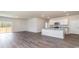 Open-concept living space with wood-look floors, island kitchen, and sliding glass door access to outdoor space at 442 Acosta Circle, Conway, SC 29527