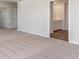 Open view of main bedroom leading to the bathroom with wood-look flooring and white cabinets at 442 Acosta Circle, Conway, SC 29527