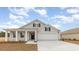 Charming single-Gathering home with a gray shingle exterior, black shutters, and a two-car garage at 4465 East Coast Ln., Shallotte, NC 28470