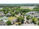 Aerial view of community with tennis courts, pool, and lush greenery with neighborhood marker at 4497 Little River Inn Ln. # 1502, Little River, SC 29566