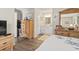 Bedroom with a view to the bathroom, wooden dresser, and ample closet space at 4497 Little River Inn Ln. # 1502, Little River, SC 29566