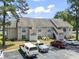 Well-maintained condo building with manicured landscaping, ample parking, and a welcoming facade at 4497 Little River Inn Ln. # 1502, Little River, SC 29566