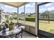 Relaxing screened porch with comfortable seating and view of community tennis courts at 4497 Little River Inn Ln. # 1502, Little River, SC 29566