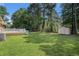 Expansive backyard with a well-maintained lawn, large trees, and a storage shed, offering ample space for activities at 450 Player St., Georgetown, SC 29440