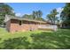 Spacious backyard featuring a deck, lush green lawn, and mature trees, perfect for outdoor entertaining and relaxation at 450 Player St., Georgetown, SC 29440