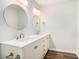 Bathroom featuring double sinks, white cabinets, quartz countertops, and modern fixtures at 450 Player St., Georgetown, SC 29440