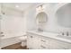 Bright bathroom featuring double sinks, quartz countertops, white cabinets, and tiled shower at 450 Player St., Georgetown, SC 29440