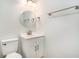 Bathroom featuring a vanity with storage and a circular mirror with modern fixtures at 450 Player St., Georgetown, SC 29440