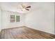 Spacious bedroom with hardwood floors, ceiling fan, and a window letting in natural light at 450 Player St., Georgetown, SC 29440