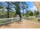 A wooden deck with white railing overlooks the surrounding yard, providing an outdoor living space at 450 Player St., Georgetown, SC 29440