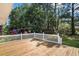 A wooden deck with white railing overlooks the yard, providing an outdoor living space at 450 Player St., Georgetown, SC 29440