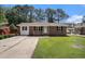 Charming brick home with a well-manicured front yard and a concrete driveway at 450 Player St., Georgetown, SC 29440