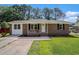 Charming brick home with a well-manicured front yard and a concrete driveway at 450 Player St., Georgetown, SC 29440