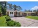 Charming brick home with a well-manicured front yard and a concrete driveway at 450 Player St., Georgetown, SC 29440