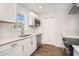 Bright kitchen features white cabinets, stainless appliances, quartz countertops, and hardwood floors at 450 Player St., Georgetown, SC 29440