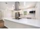 Modern kitchen featuring stainless steel appliances, white countertops, and sleek pendant lighting at 450 Player St., Georgetown, SC 29440