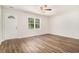 Bright living room with hardwood floors, a ceiling fan, and a view of the front yard at 450 Player St., Georgetown, SC 29440