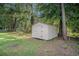 Durable outdoor storage shed in the backyard providing space for gardening tools and equipment, surrounded by mature trees at 450 Player St., Georgetown, SC 29440