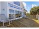 Inviting back deck features rocking chairs, ample seating, and sliding glass doors for seamless indoor-outdoor living at 4616 Eyerly St., North Myrtle Beach, SC 29582