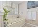 Bathroom features a jacuzzi tub, tiled floor, and natural light, creating a spa-like retreat at 4616 Eyerly St., North Myrtle Beach, SC 29582