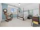 Bedroom featuring a four poster bed, rocking chair, and plenty of natural light at 4616 Eyerly St., North Myrtle Beach, SC 29582