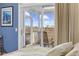 Bedroom view to screened porch with marsh views and exterior chairs at 4616 Eyerly St., North Myrtle Beach, SC 29582