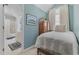 Cozy bedroom features white walls, a patterned duvet and attached bathroom at 4616 Eyerly St., North Myrtle Beach, SC 29582