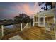 Inviting wooden deck with rocking chairs, offering picturesque views of the marsh and vibrant sunset at 4616 Eyerly St., North Myrtle Beach, SC 29582