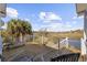 Spacious wooden deck overlooking a serene marsh with lounge chairs and a seating area under a clear sky at 4616 Eyerly St., North Myrtle Beach, SC 29582