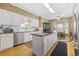 Well-lit kitchen with island, stainless steel appliances, and breakfast area at 4616 Eyerly St., North Myrtle Beach, SC 29582
