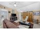 Living room with leather sofa, entertainment center, bookcase and ceiling fan at 4616 Eyerly St., North Myrtle Beach, SC 29582