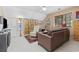 Living room featuring a leather couch, guitars and a large shelving unit at 4616 Eyerly St., North Myrtle Beach, SC 29582