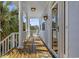 Inviting porch with white columns, rocking chairs, and a view of the surrounding landscape at 4616 Eyerly St., North Myrtle Beach, SC 29582