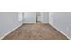 Carpeted bedroom showing doorway to an en suite bathroom at 478 Samara Dr., Longs, SC 29568
