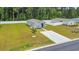 Aerial view of gray home with white privacy fence, manicured landscaping, and a long concrete driveway at 478 Samara Dr., Longs, SC 29568
