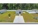 Aerial view of gray home with landscaping and long driveway, complemented by a white privacy fence at 478 Samara Dr., Longs, SC 29568