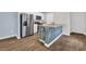The kitchen features stainless steel appliances and an island with wood-style paneling at 478 Samara Dr., Longs, SC 29568