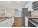 Open-concept kitchen with stainless steel appliances flowing into a living area at 478 Samara Dr., Longs, SC 29568
