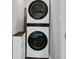 A modern laundry area with stacked washer and dryer units for optimal space saving at 478 Samara Dr., Longs, SC 29568