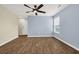 A bright living room with wood floors, a ceiling fan, and a large window at 478 Samara Dr., Longs, SC 29568