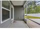 View of covered patio featuring ceiling fan, exterior door and large screened windows overlooking the backyard at 478 Samara Dr., Longs, SC 29568