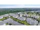 Aerial view of apartment complex on waterfront with mature trees and a glimpse of the city skyline in the distance at 4887 Luster Leaf Circle # 105, Myrtle Beach, SC 29577