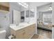 Well-lit bathroom with double sinks and doorway to bedroom at 4887 Luster Leaf Circle # 105, Myrtle Beach, SC 29577