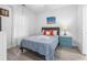 Bright bedroom with natural light, complemented by a blue, nautical themed side table and a cozy queen bed at 4887 Luster Leaf Circle # 105, Myrtle Beach, SC 29577