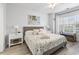 Bright bedroom with ceiling fan, coastal decor, and a view to the bathroom at 4887 Luster Leaf Circle # 105, Myrtle Beach, SC 29577