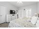 Bright bedroom features a TV, dresser, and view through a doorway to other rooms at 4887 Luster Leaf Circle # 105, Myrtle Beach, SC 29577