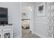 Hallway with gray walls leads to the bedroom featuring coastal decor and a ceiling fan at 4887 Luster Leaf Circle # 105, Myrtle Beach, SC 29577