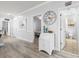 Hallway features neutral walls, a decorative clock, and a view to the bedroom and bathroom at 4887 Luster Leaf Circle # 105, Myrtle Beach, SC 29577