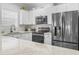 Modern kitchen featuring white cabinetry and stainless steel appliances at 4887 Luster Leaf Circle # 105, Myrtle Beach, SC 29577